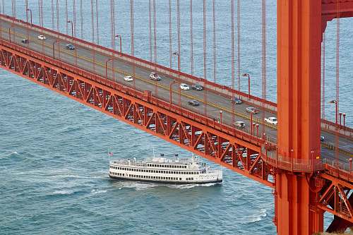 boat white cruise ship under concrete bridge ferry